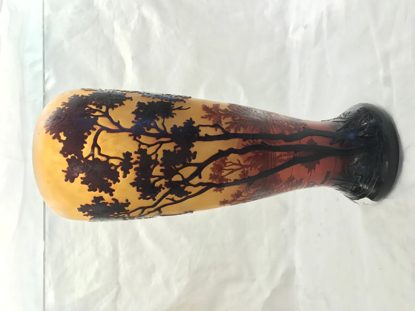 Carved glass featuring tree motifs in warm tones, antique.