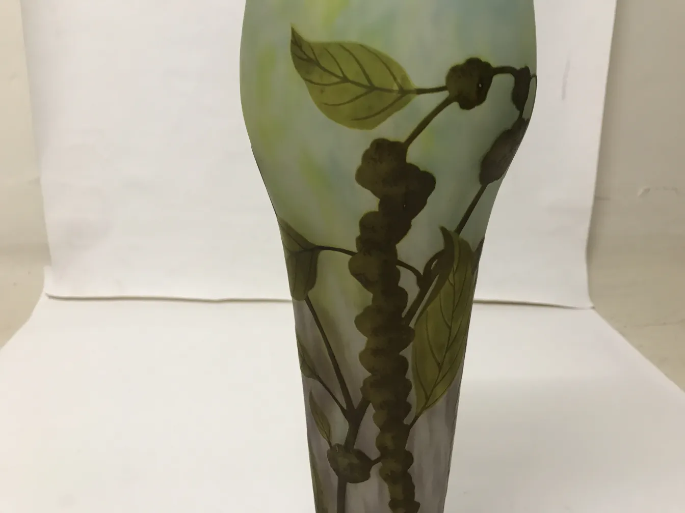 Signed Daum Nancy glass with leaf design on light background