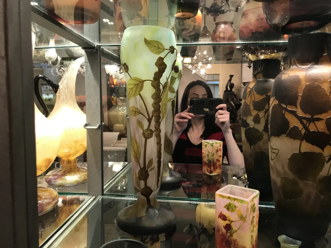 antique signed glass from Daum Nancy featuring leaf design, displayed in a cabinet