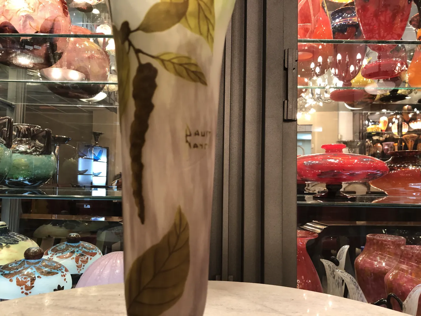 vase with leaves and daum nancy signature, decorative background