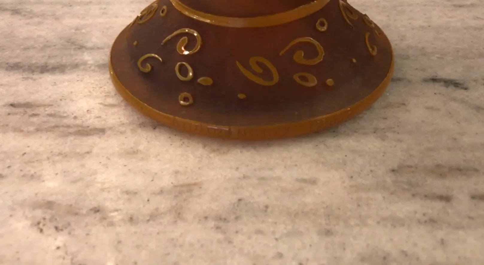 Brown glass base with decorative patterns