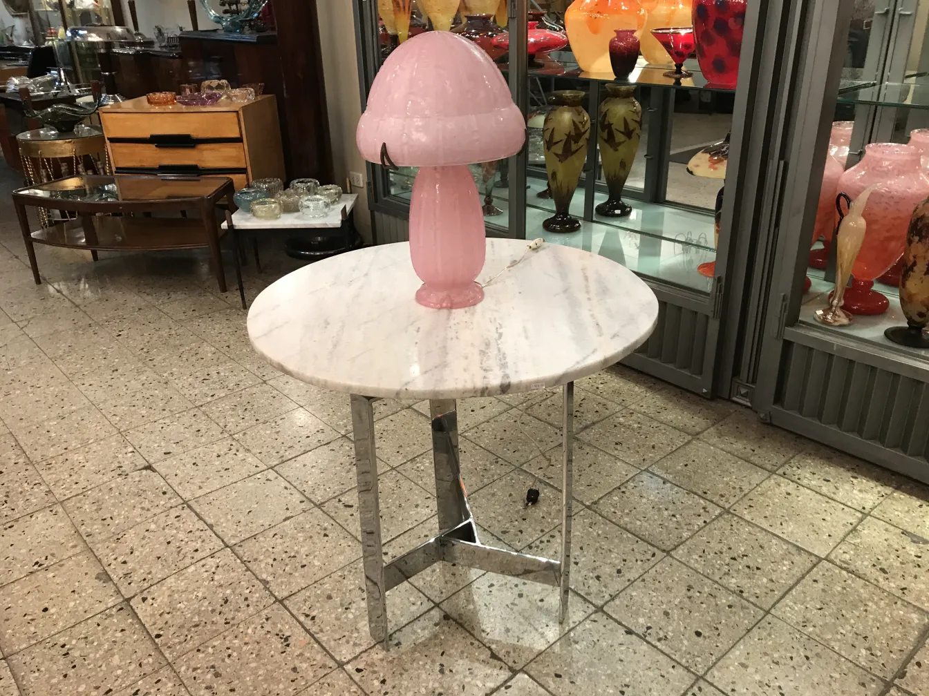 Signed glass Daum Nancy on a white table with a pink lamp in an antique environment.