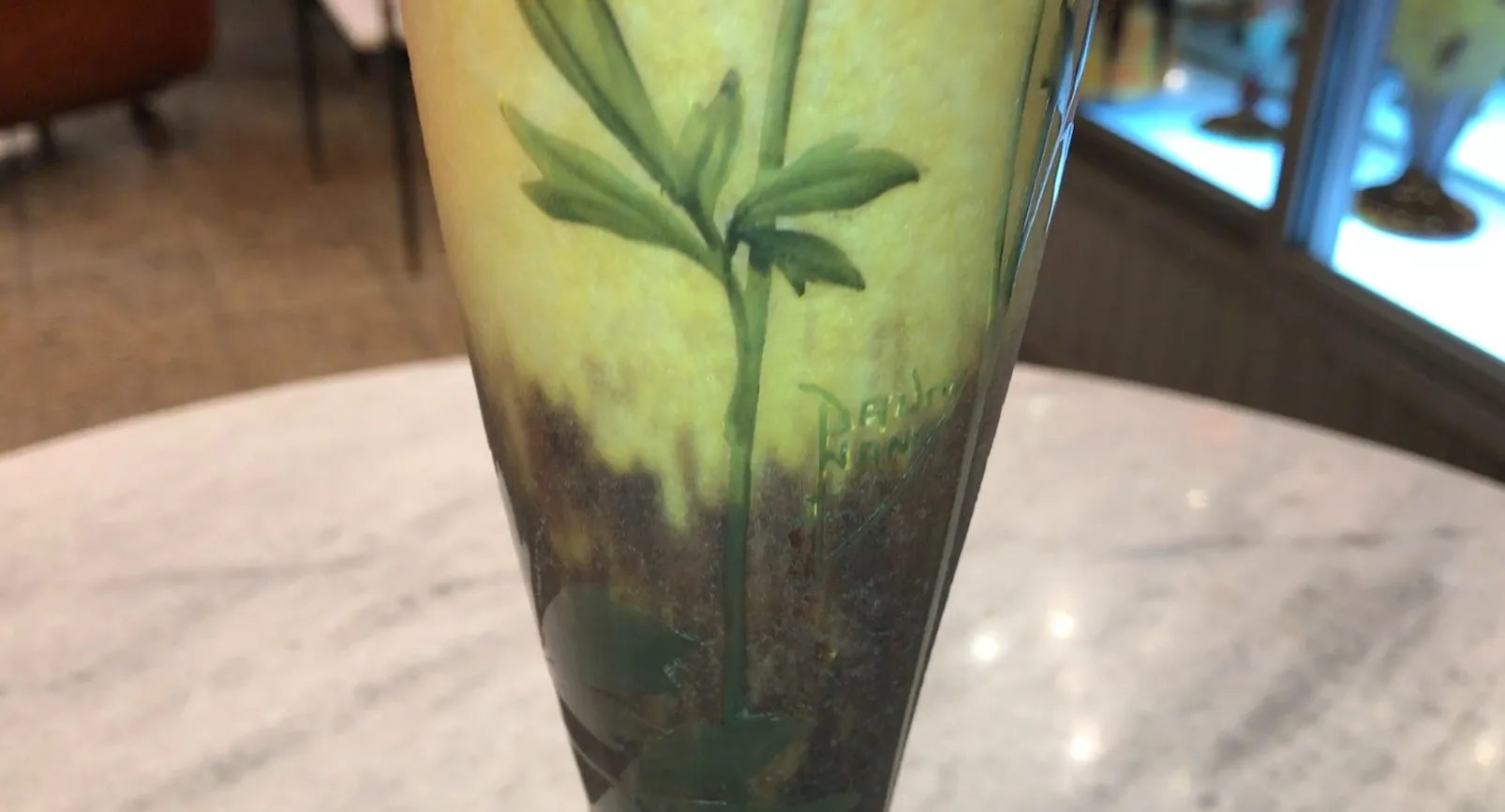 signed glass with leaf and flower designs in yellow and brown tones