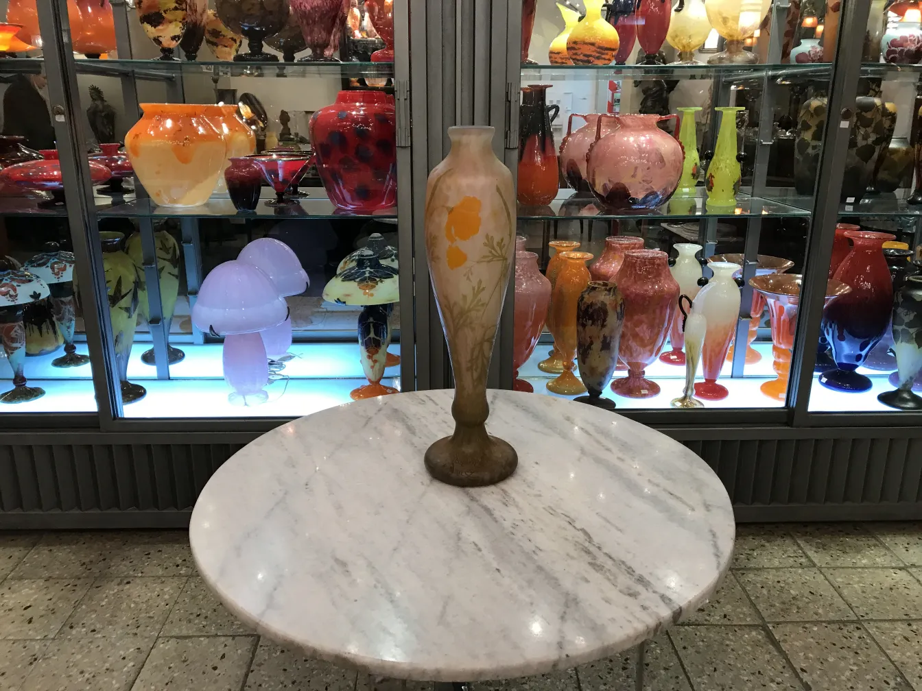 pieza antigua de vidrio con flores, fondo variado de jarrones de colores