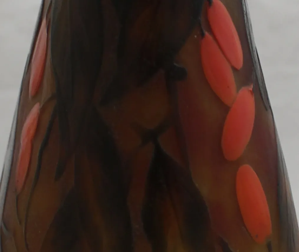 Antique glass featuring dark colors and red accents, reminiscent of Daum Nancy style.