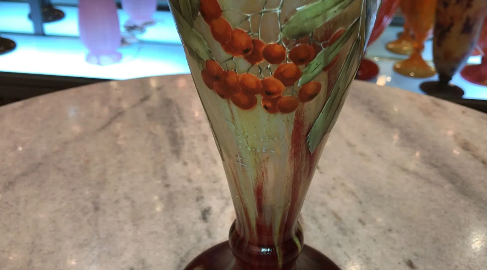 Antique signed glass Daum Nancy featuring warm-toned leaf and berry decoration, light background.