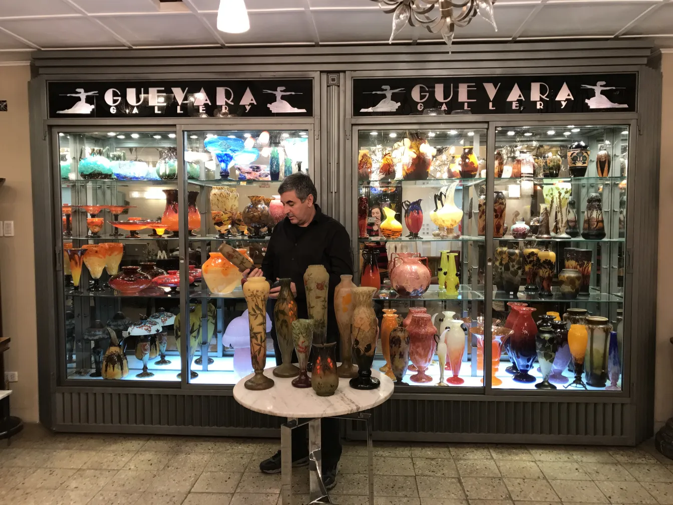 Vetro firmato di Daum Nancy in una galleria antica, varie forme e colori esposti su uno scaffale