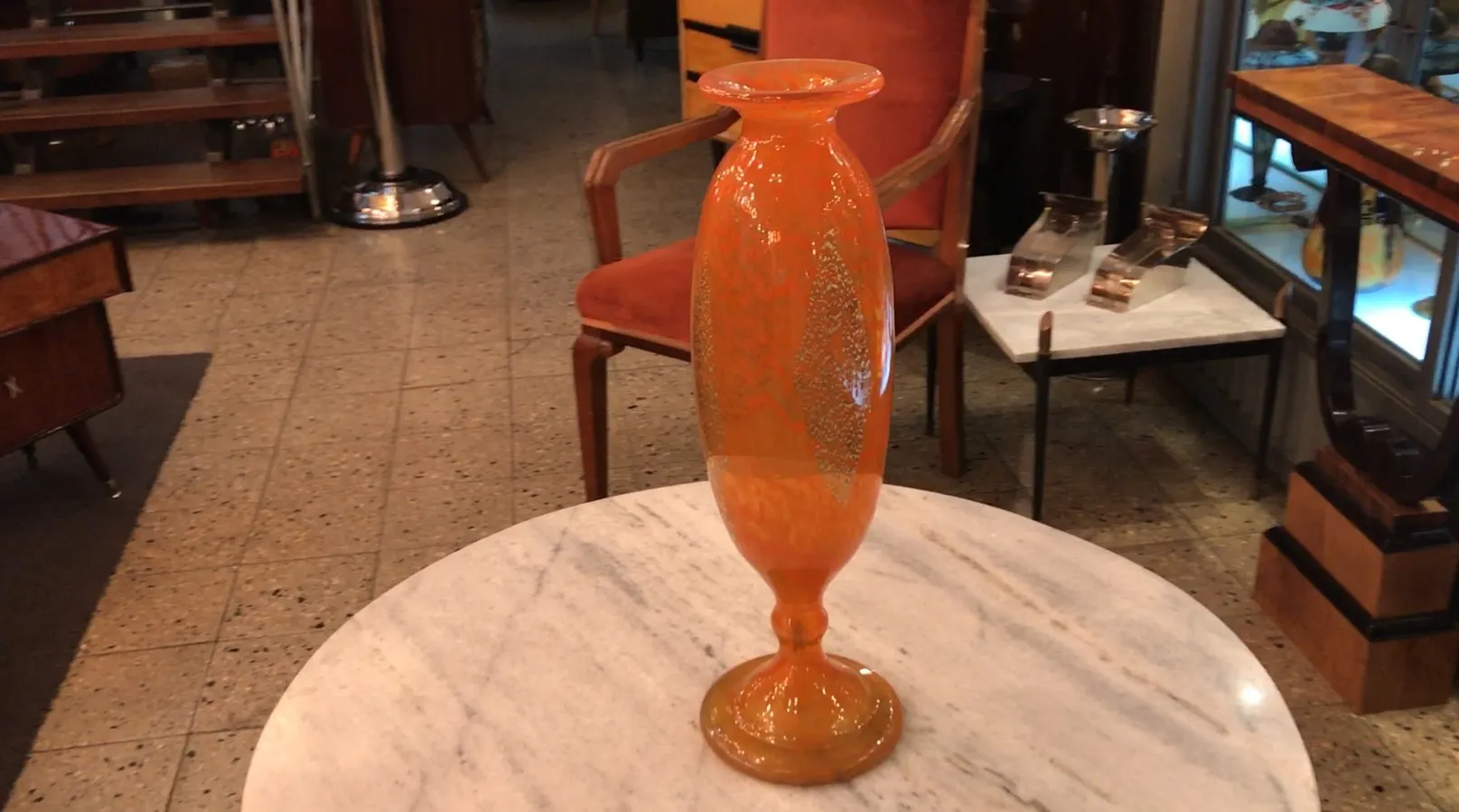 Verre signé Daum Nancy orange avec design décoratif dans un cadre d'antiquités.