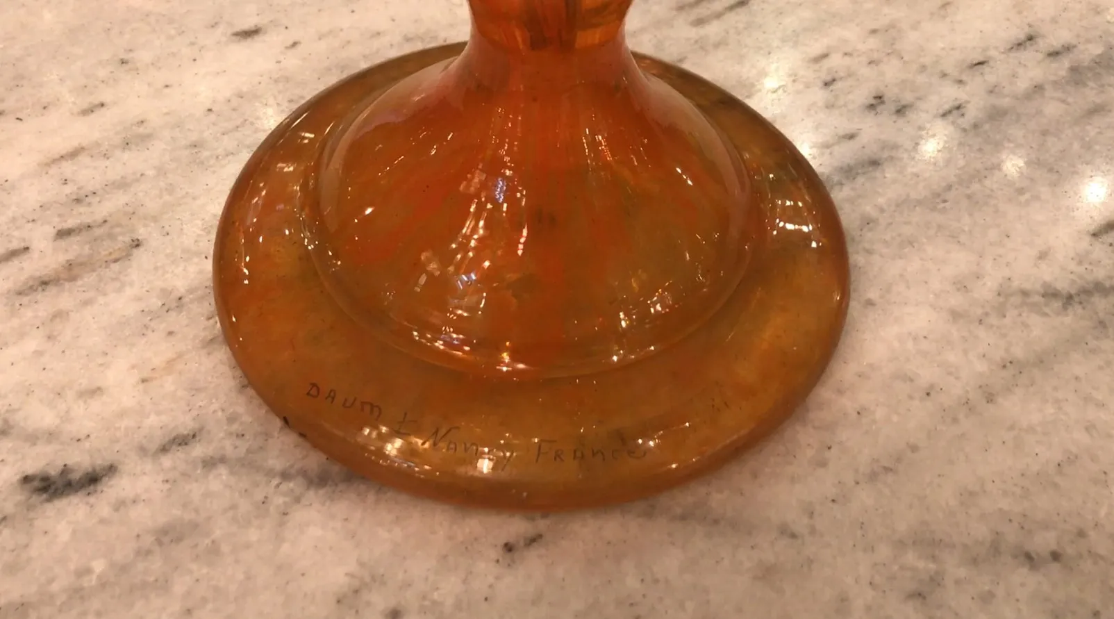 orange glass with visible signature of Daum Nancy