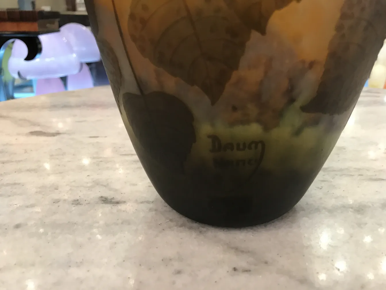 Antique signed glass by Daum Nancy featuring engraved leaves.