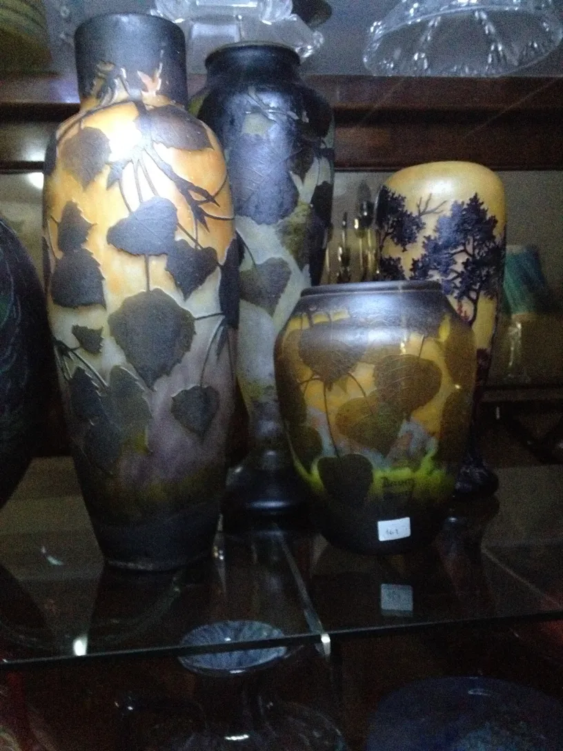 Set of decorative Daum Nancy vases in display case