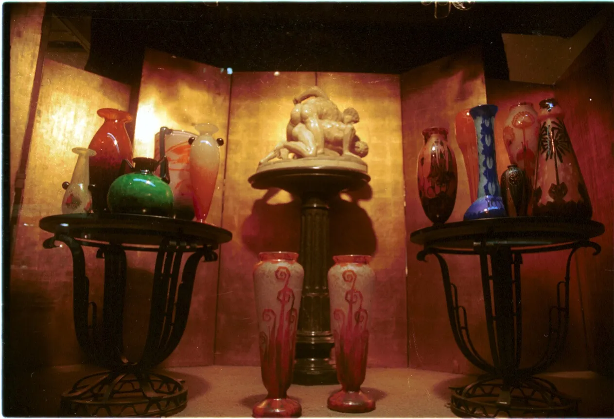 two decorated vases with antique designs in a display case