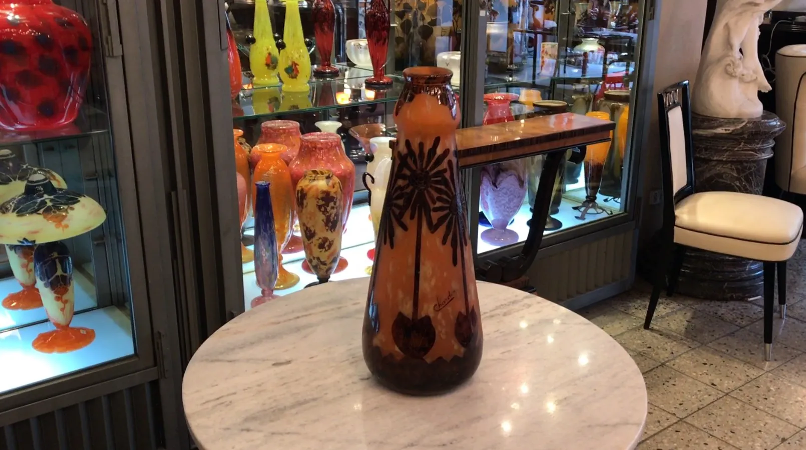 Antique signed glass Charder on a marble table.