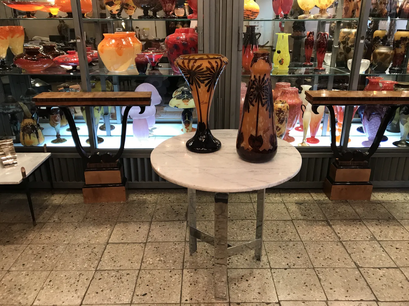 Signed glass Charder displayed among colorful antiques.