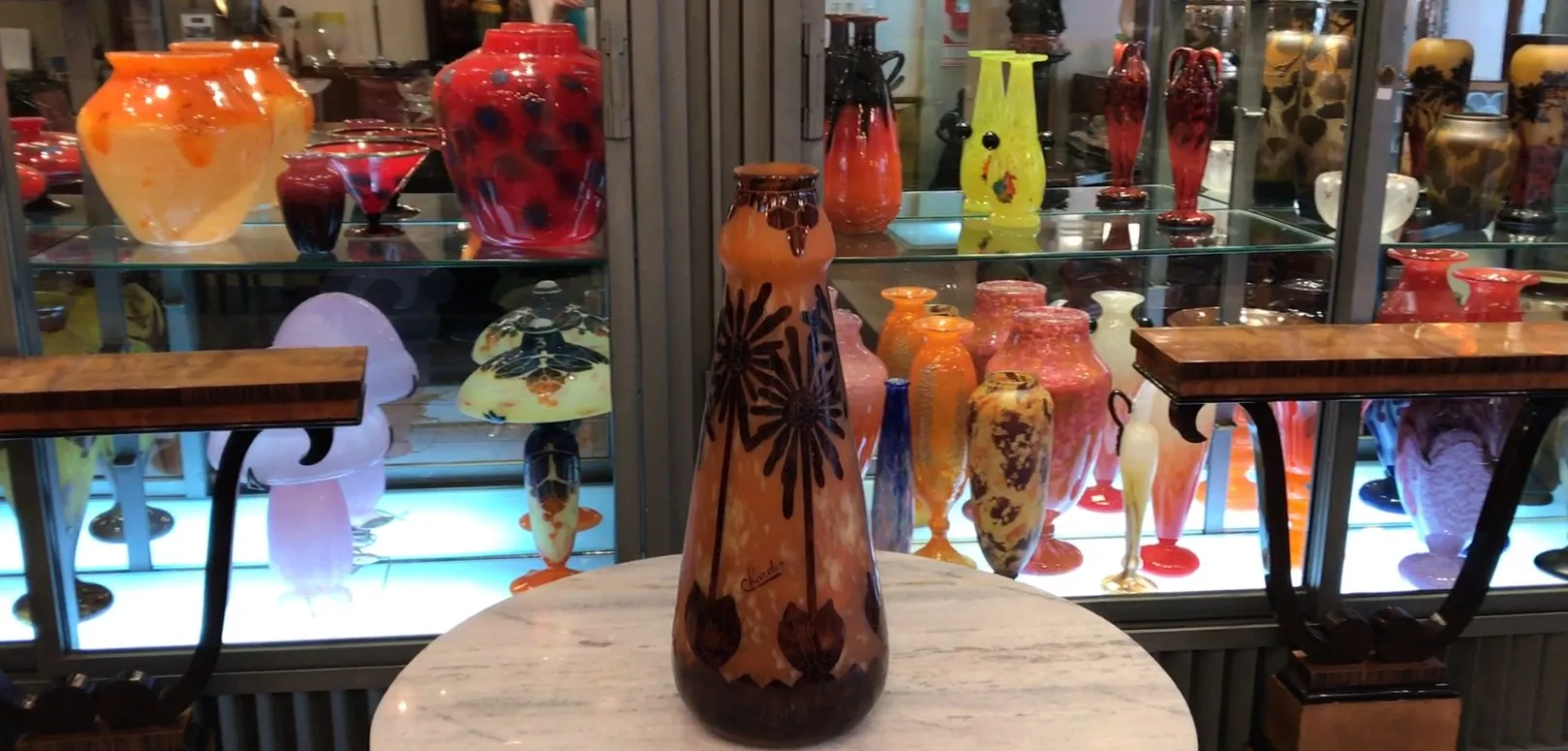 signed glass in warm tones with floral design, antique