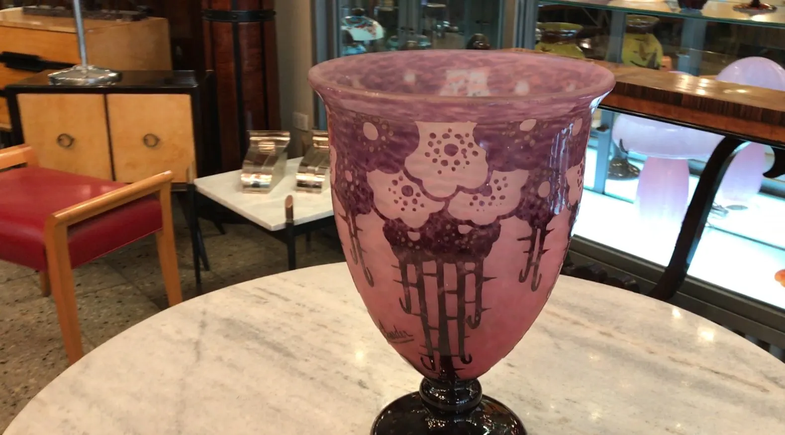 Antique signed Charder vase with purple details on a pink background.