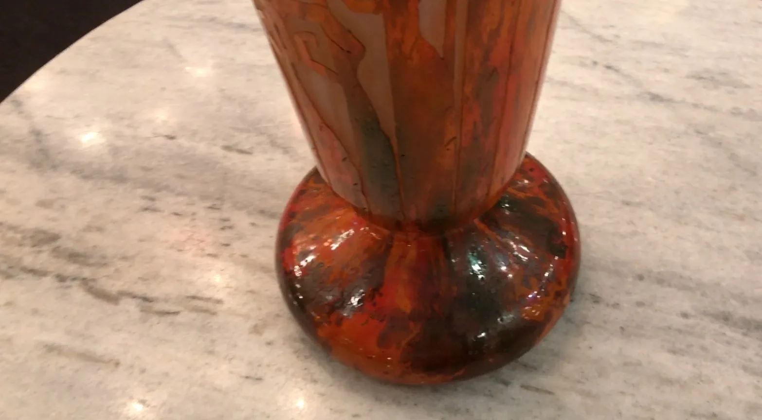 Antique signed glass Charder with vibrant colors and unique design on a round base, set on a clear surface.
