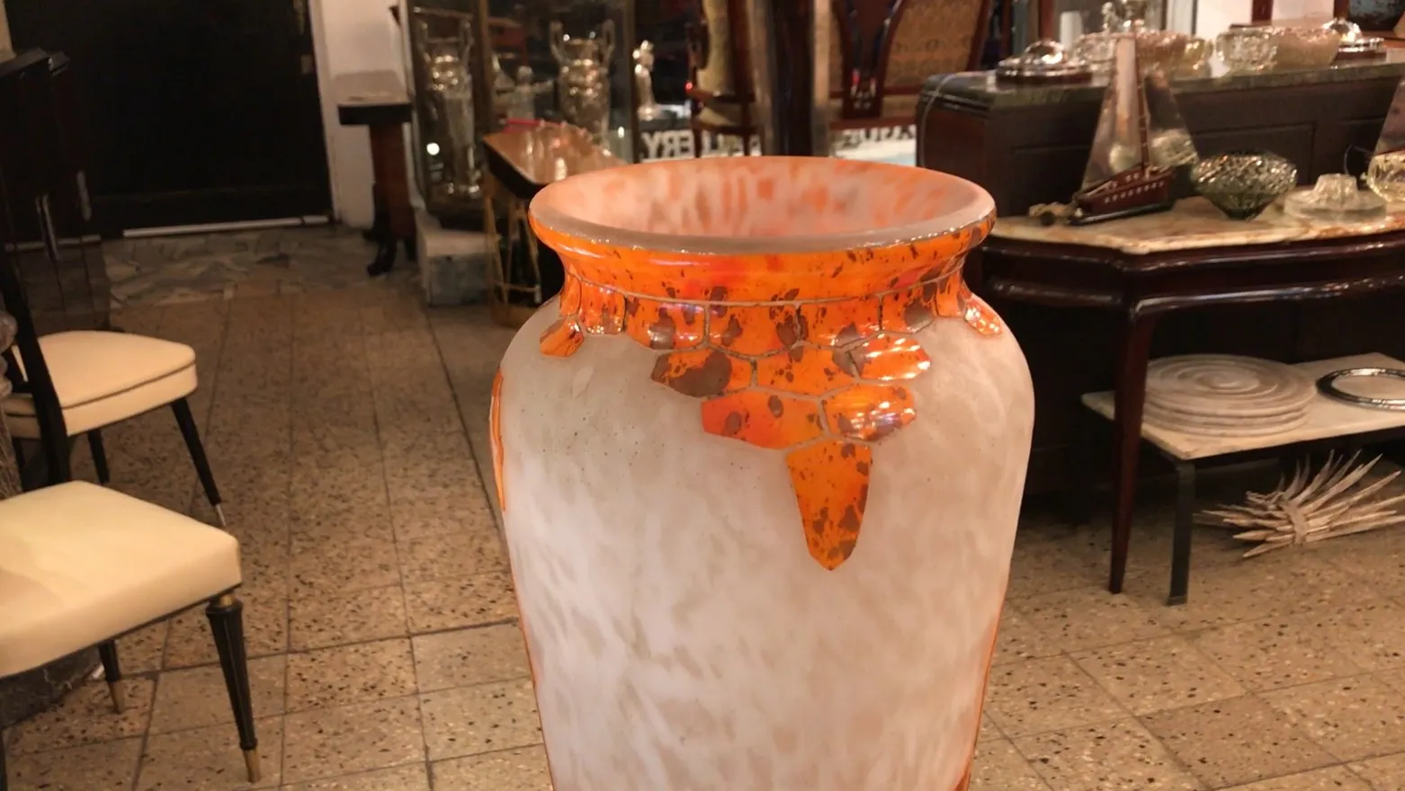 Antique signed glass Charder, featuring orange details, set against a classic decor.