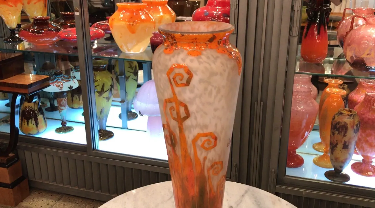 Antique signed glass Charder with orange decoration, light background.