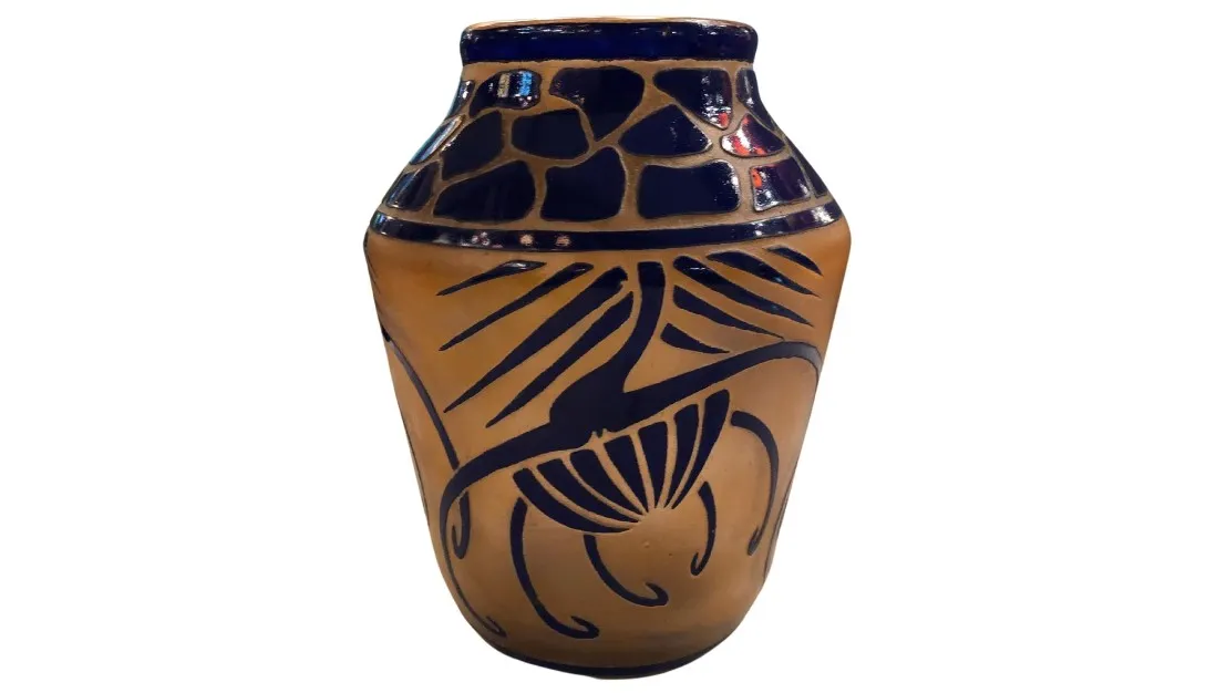Signed glass Charder with warm and blue decorative patterns.