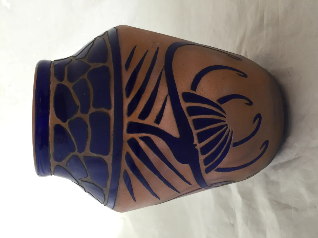 View of an antique signed glass Charder with blue decorations.