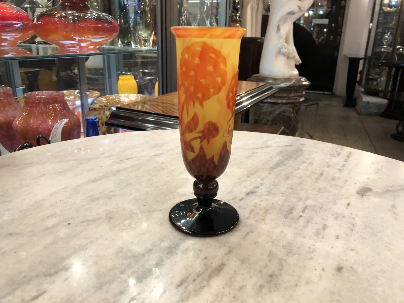 Vase en verre signé Charder avec des teintes orange et base noire dans un cadre d'antiquités.