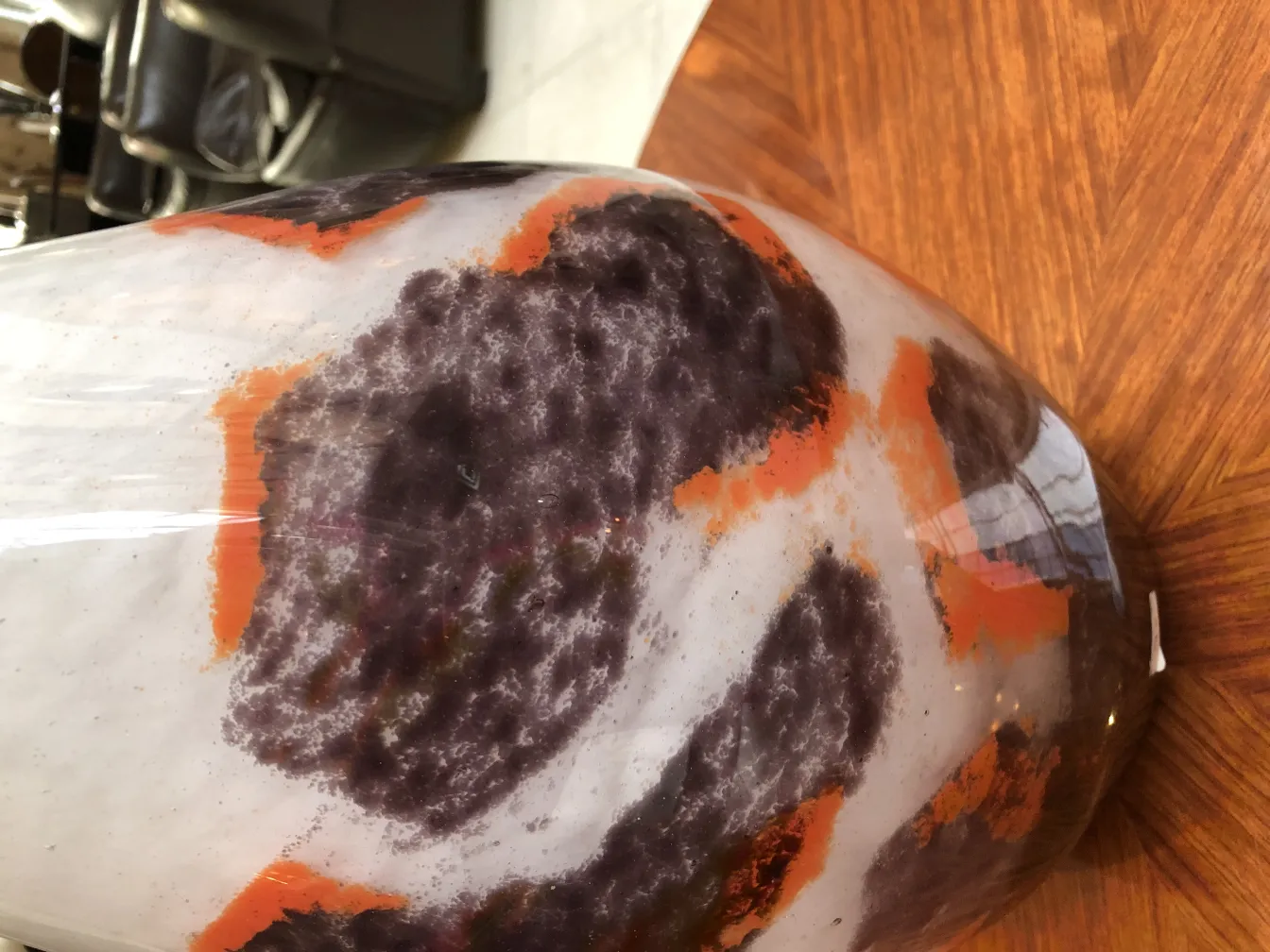 Signed Degué glass with colorful patterns on light background