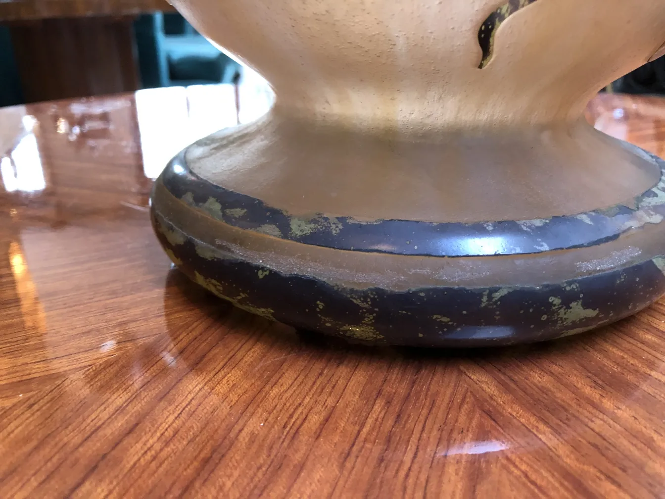 View of the base of a signed glass Degué in an elegant setting.