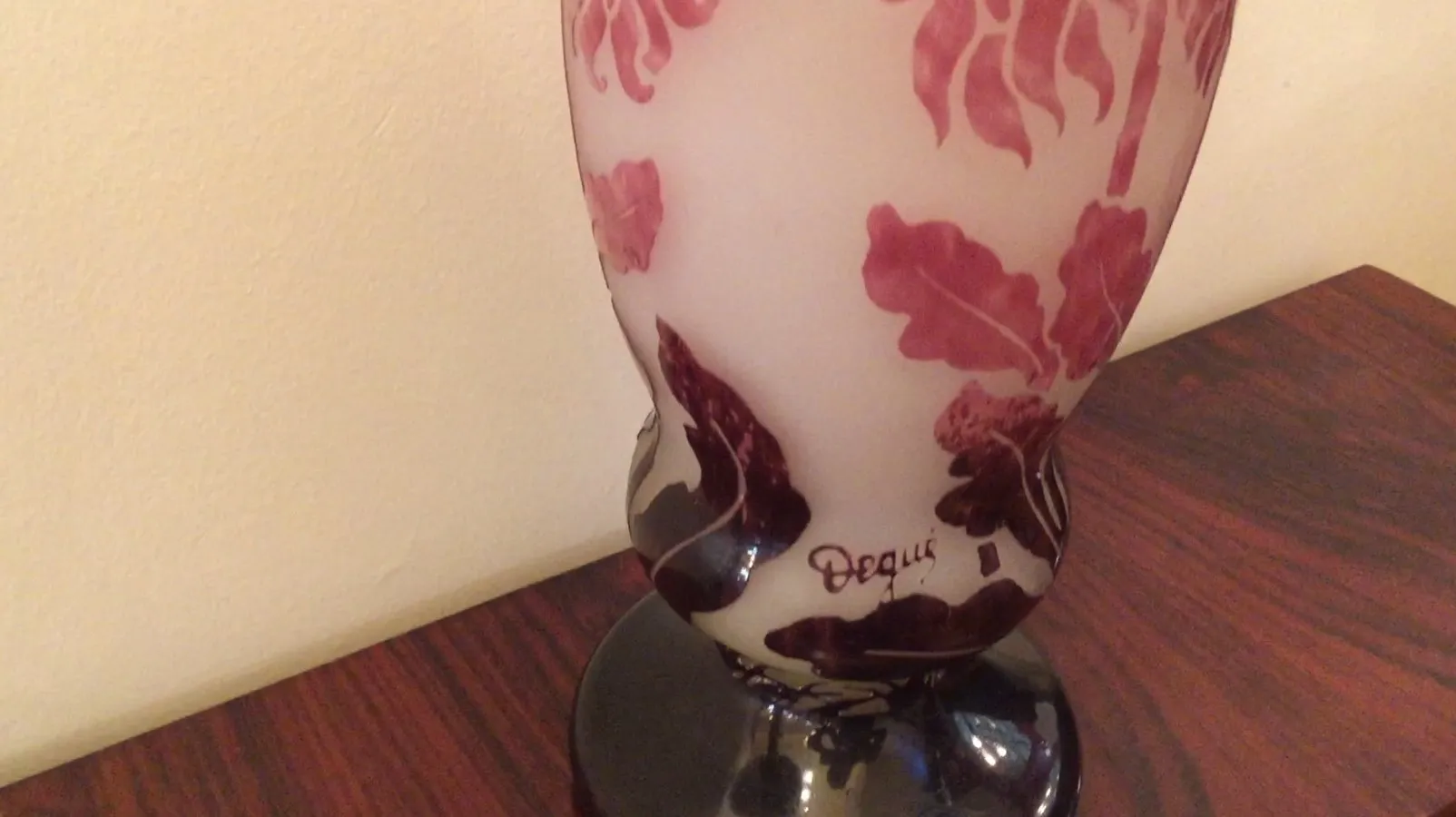 Antique signed glass by Degué with red and black designs.