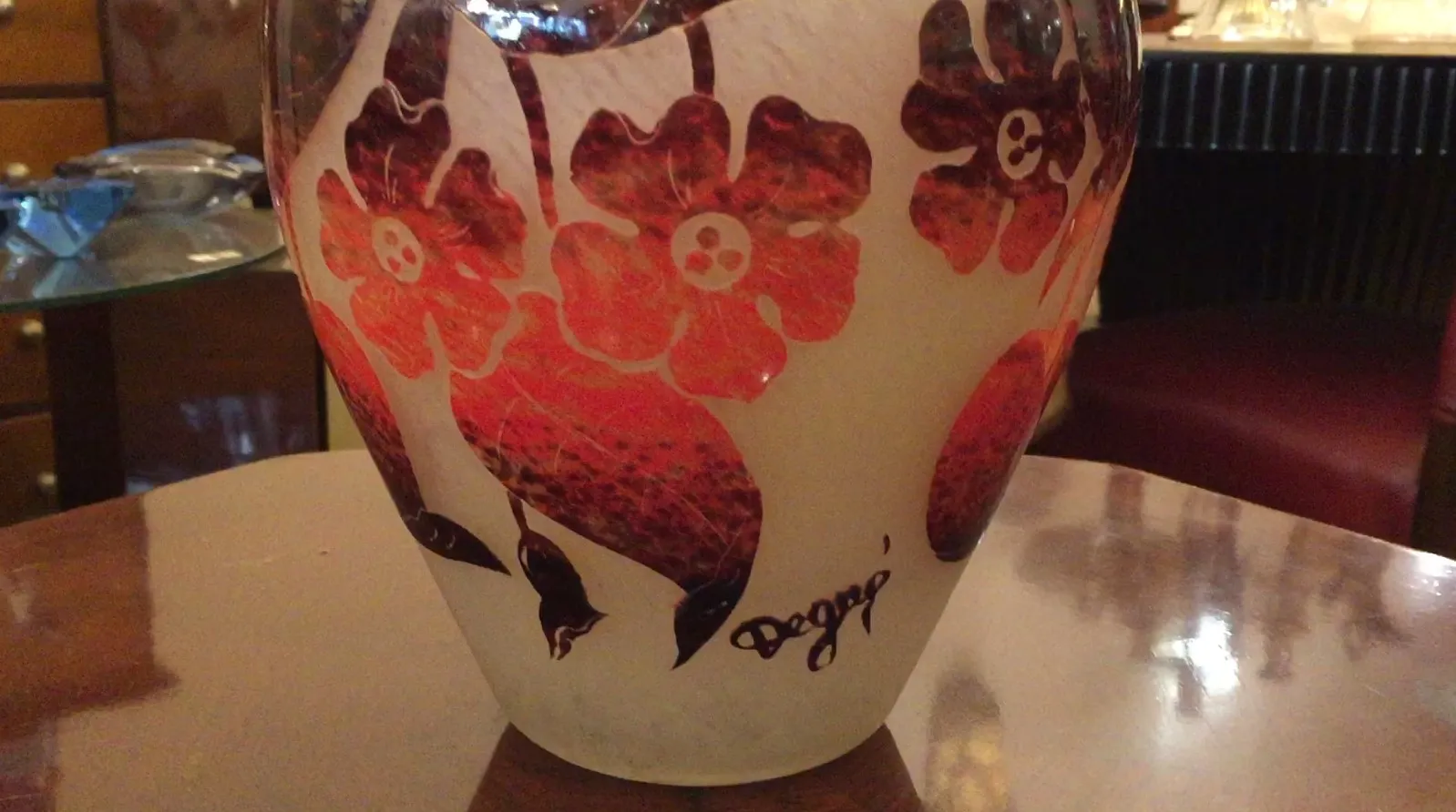 Antique signed glass Degué with red flowers, clear background.