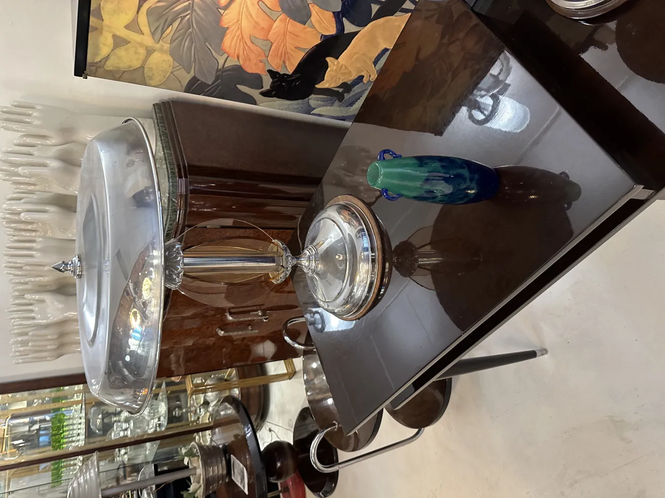 signed glass Degué on a table with antique decor