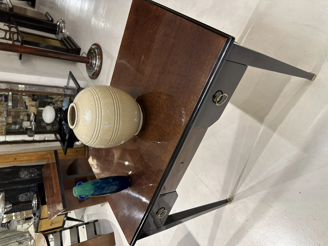 Antique table with a vase and bottle on it