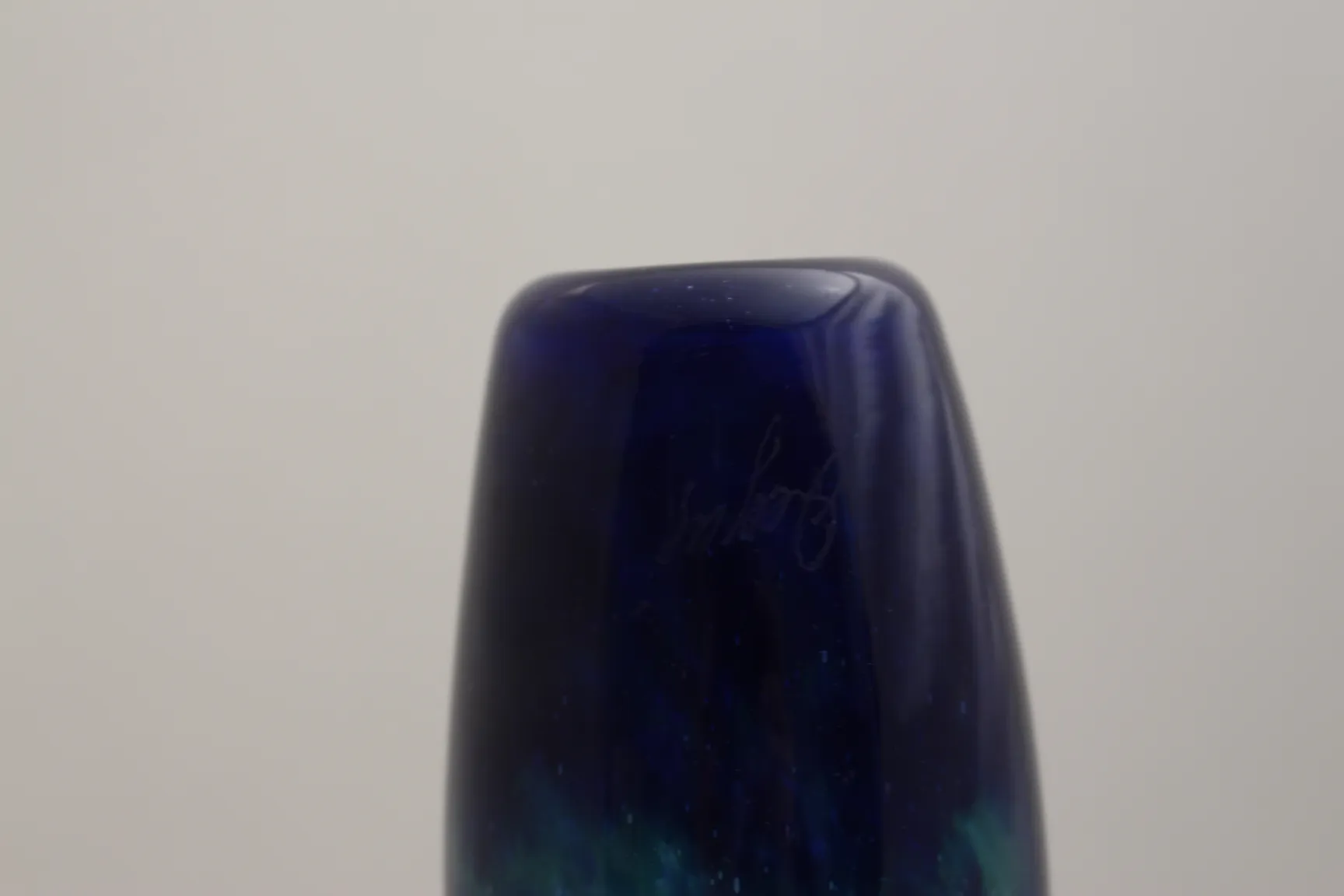 Antique signed glass Degué, dark blue, with visible signature.