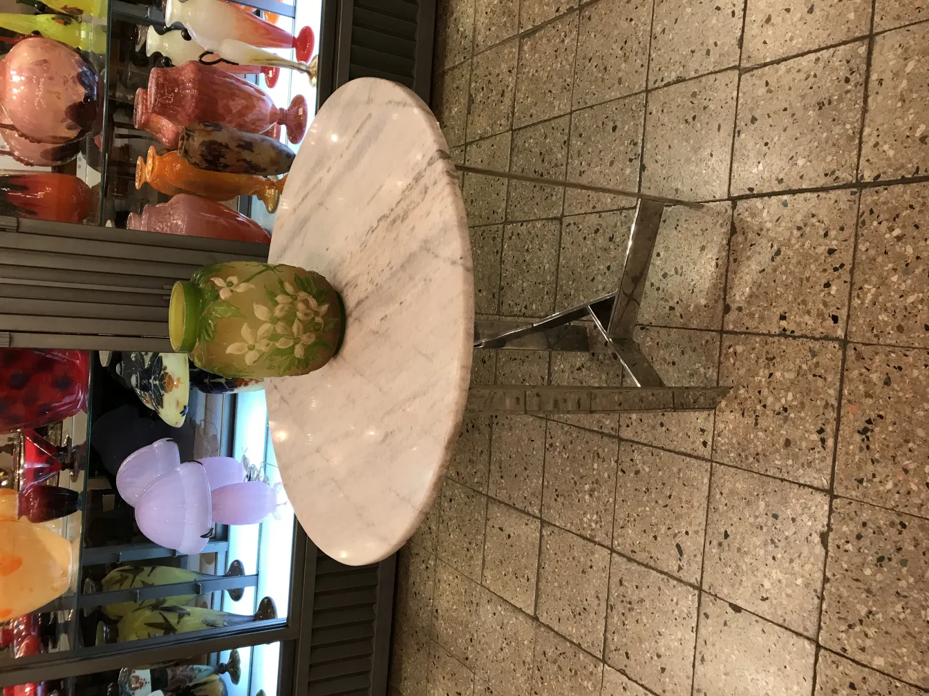 Signiertes Glas Galle mit floraler Dekoration in einer antiken Umgebung.