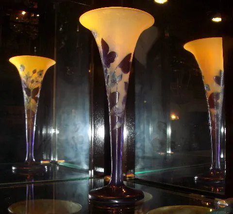 Signed Gallé glass featuring floral design in an elegant setting