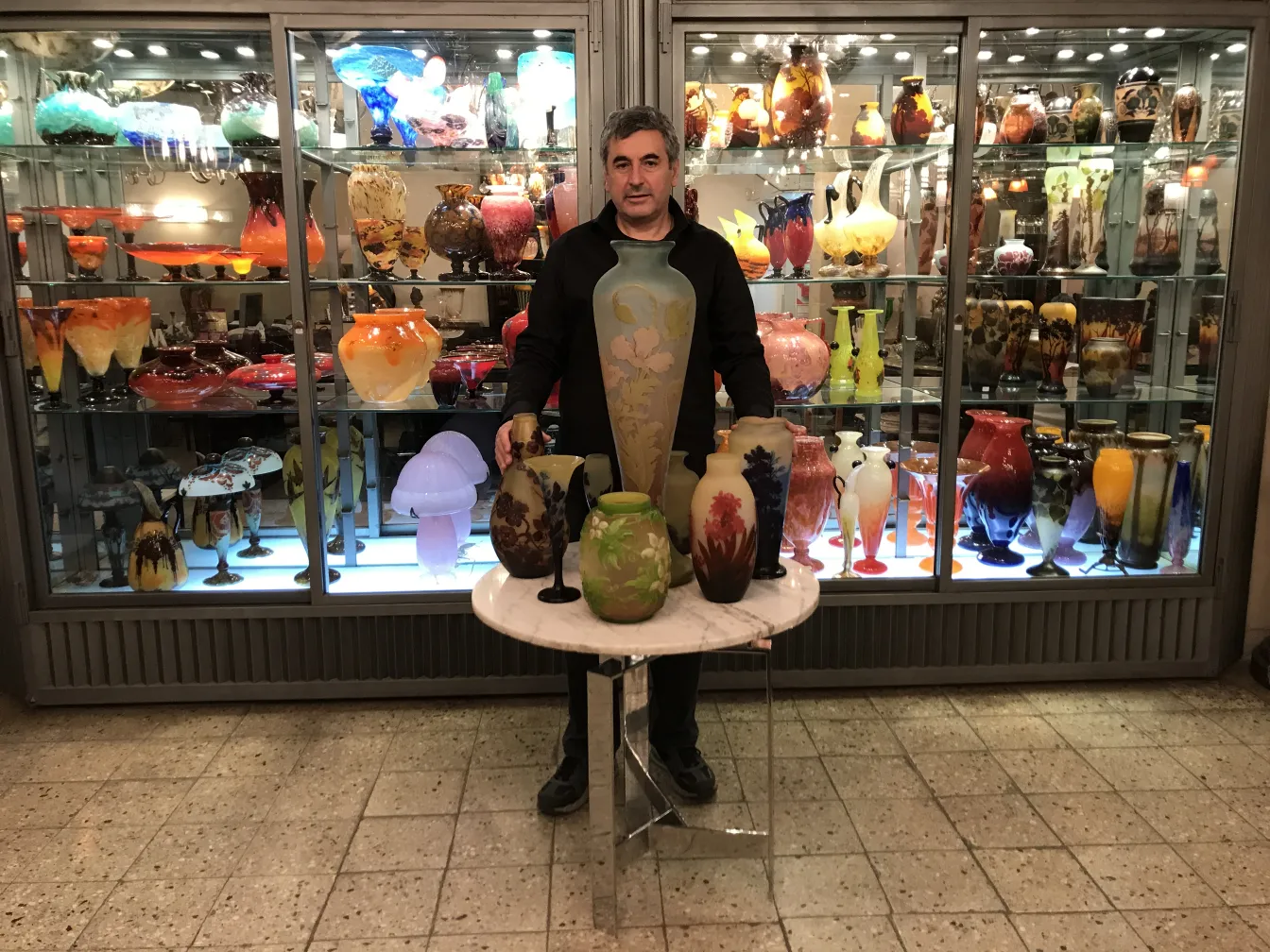 古老的签名玻璃 gallé 中多彩的颜色流动，旁边还有其他装饰品，环境舒适