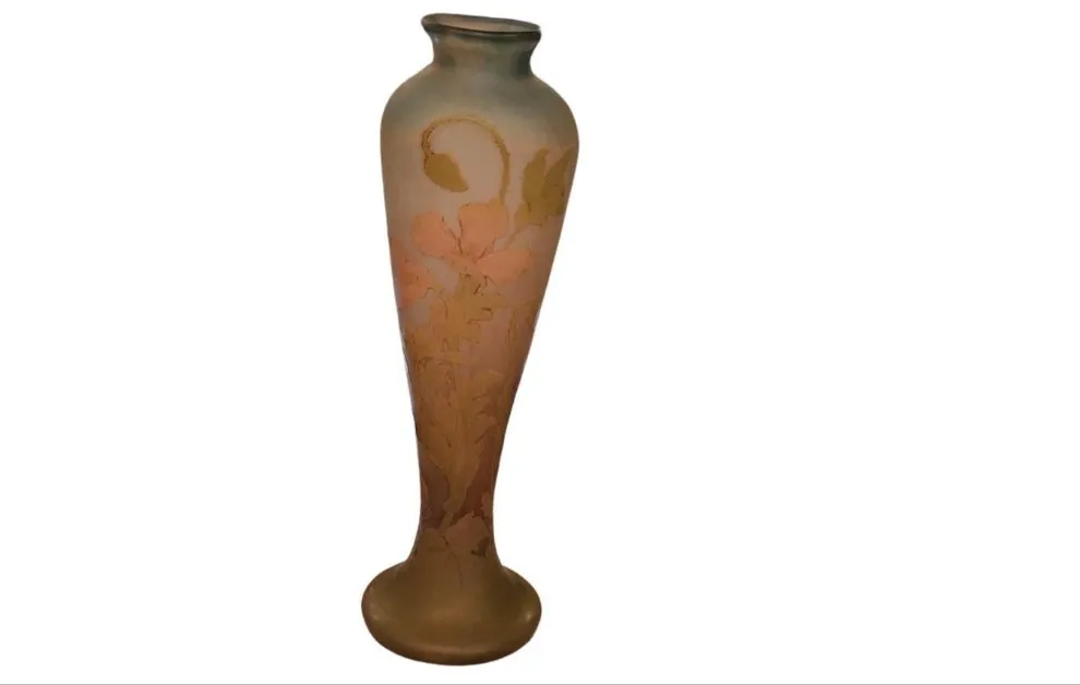 Bouteille ancienne en verre avec décoration florale et signature.