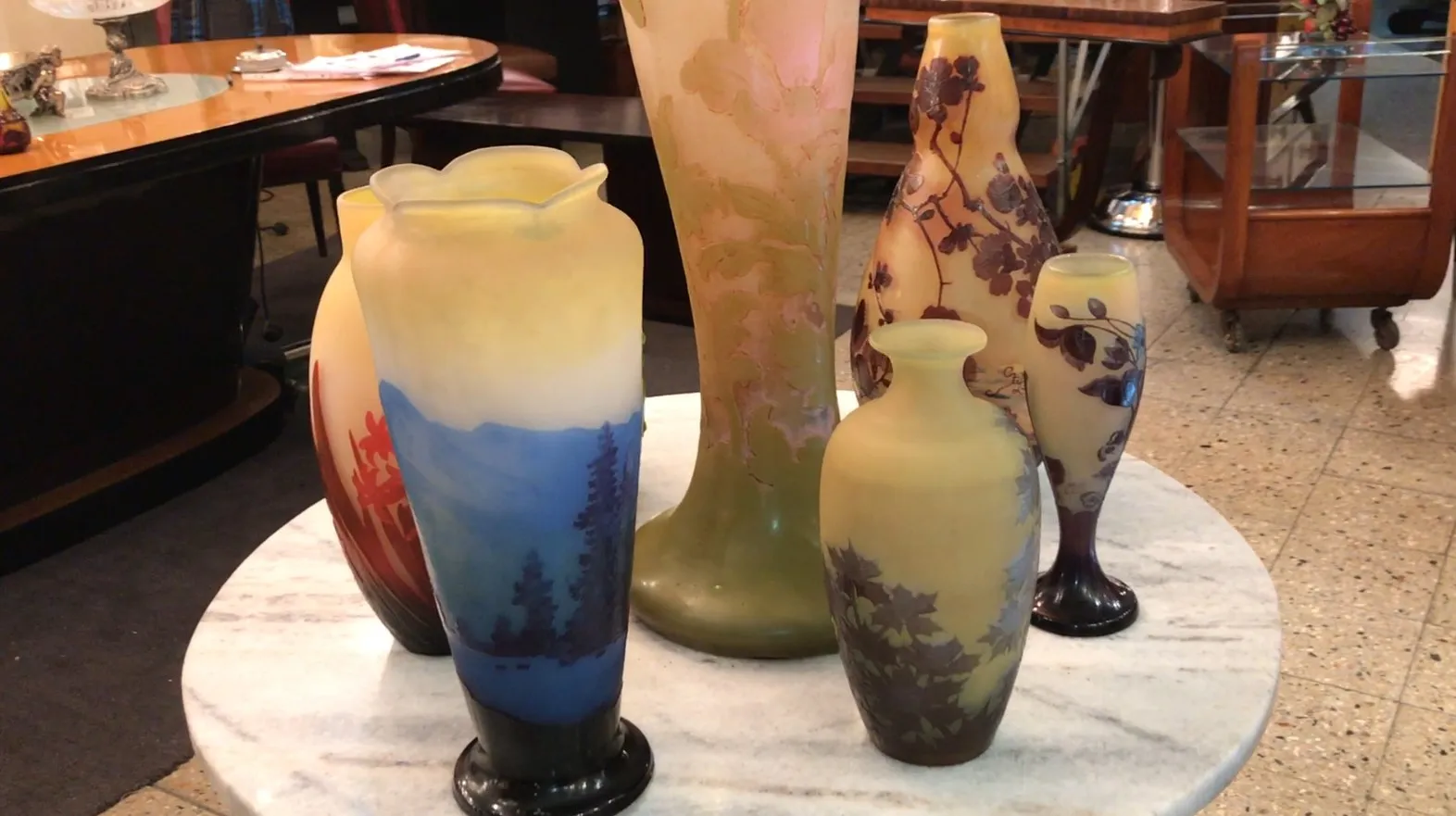 Collection d'antiquités avec du verre signé Gallé, couleurs variées.