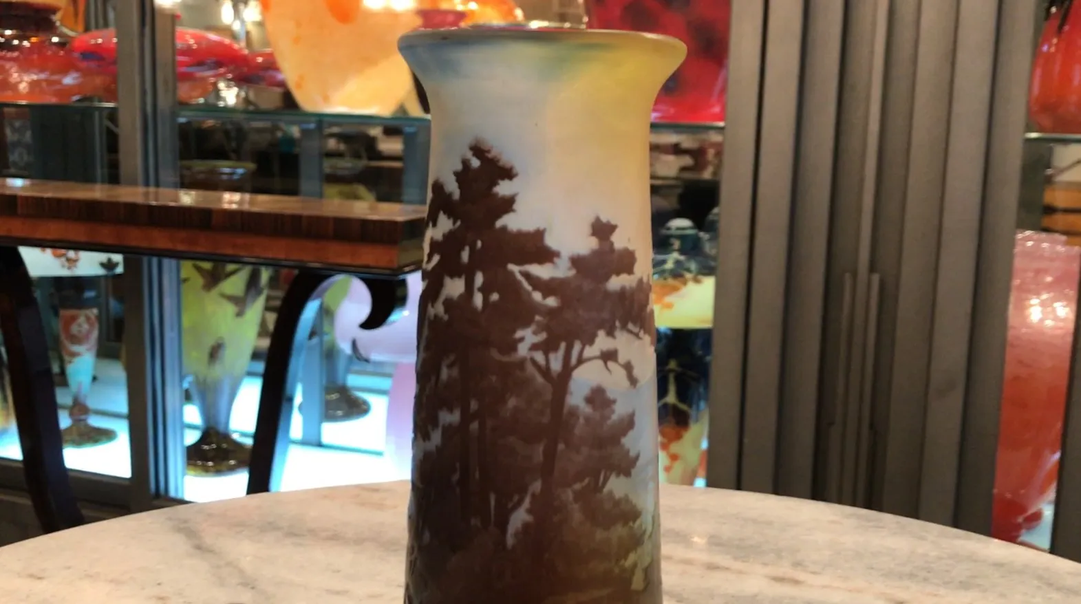 signed glass Gallé featuring a soft-toned tree landscape