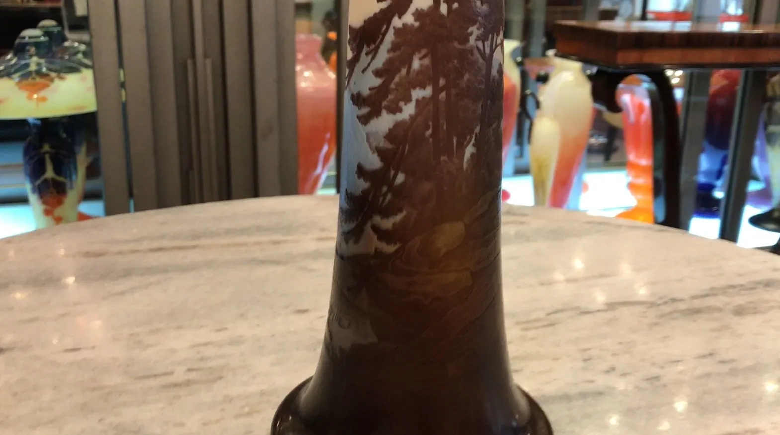 Antiquität signiertes Glas Gallé mit Baummotiv auf braunem Hintergrund.