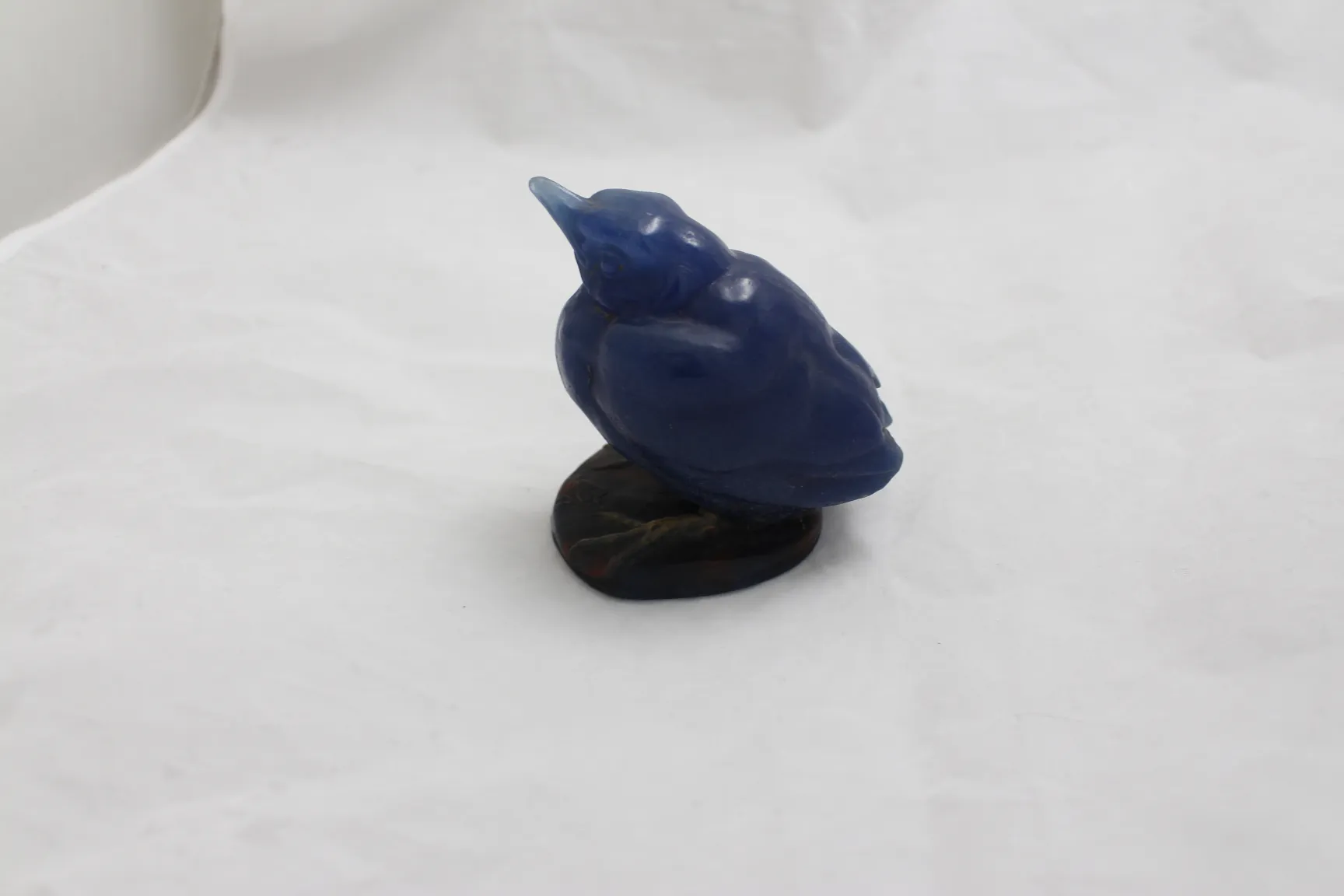 Decorative signed glass bird figurine in blue color on a base