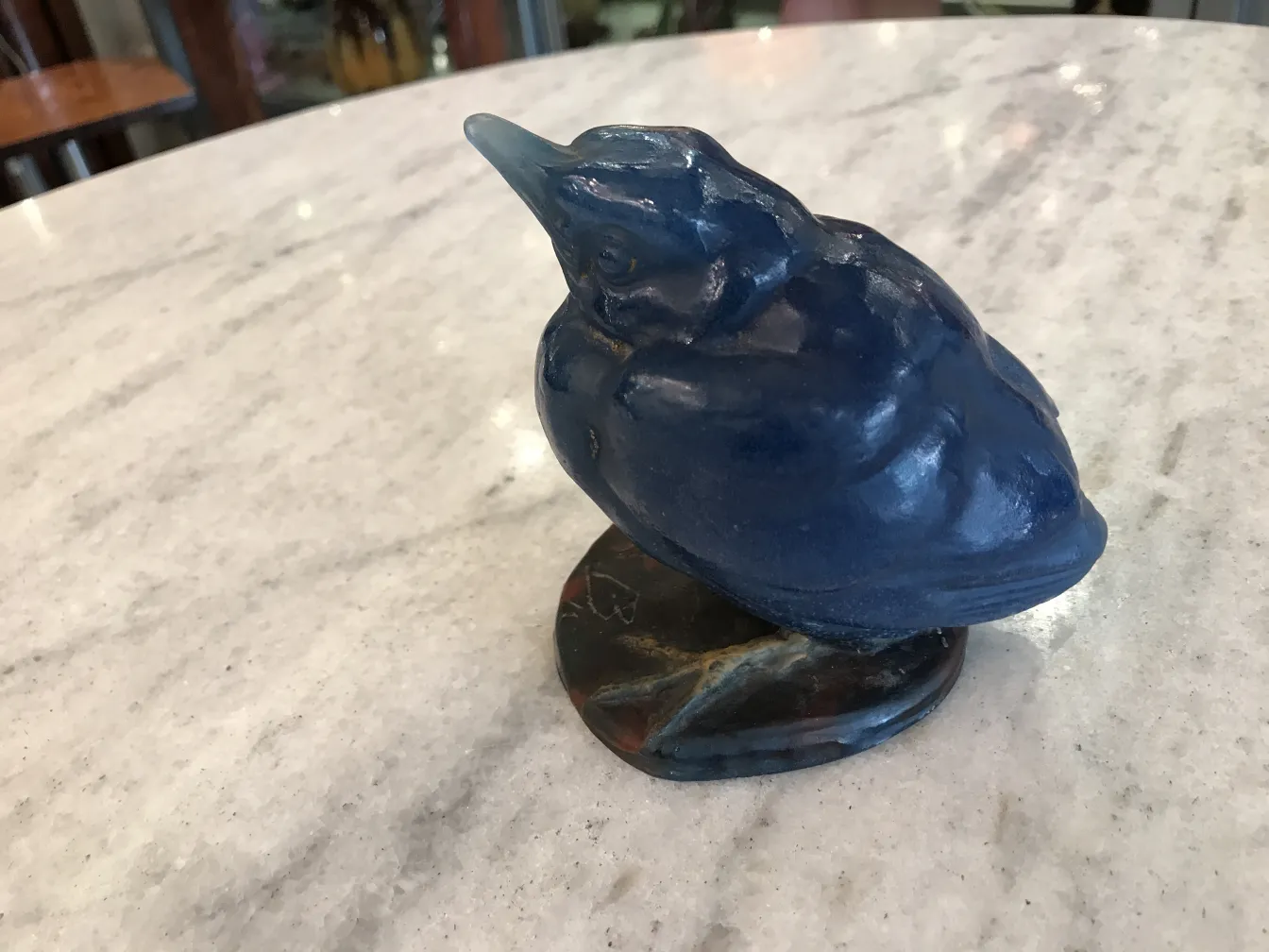 Antique signed glass in the shape of a blue bird on marble