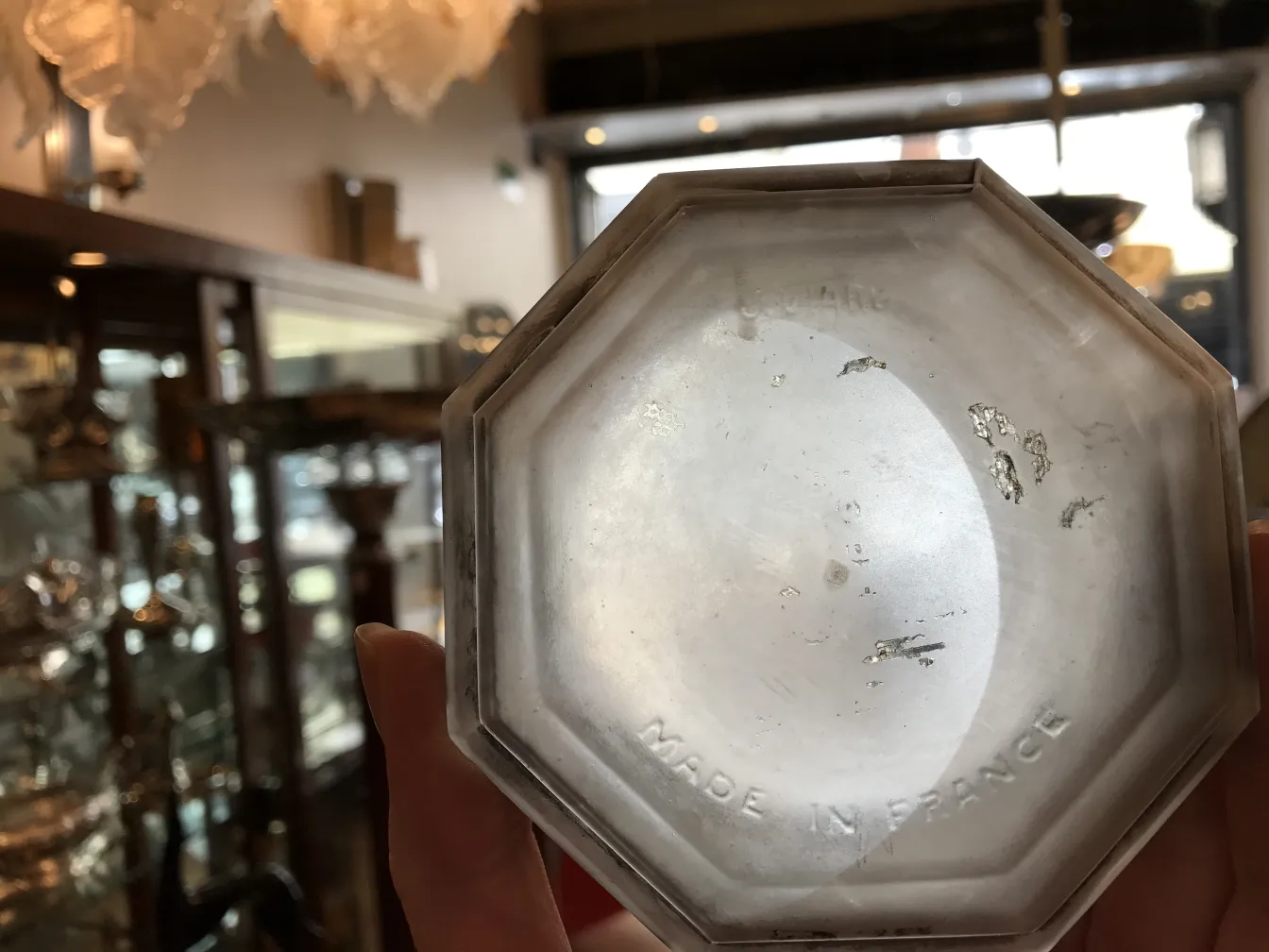 View of the bottom of a signed glass with octagonal shape and visible marks