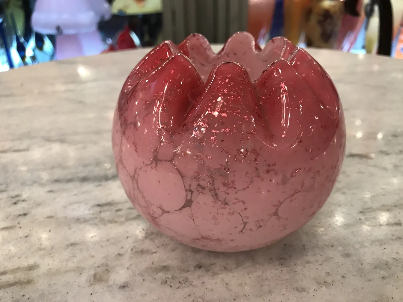 Signed glass with pink color and a unique texture.