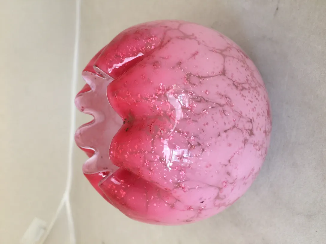 signed glass in decorative shape with pink tones and unique details