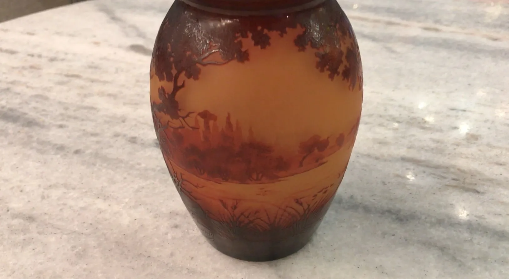 signed glass d'argental featuring a warm natural landscape