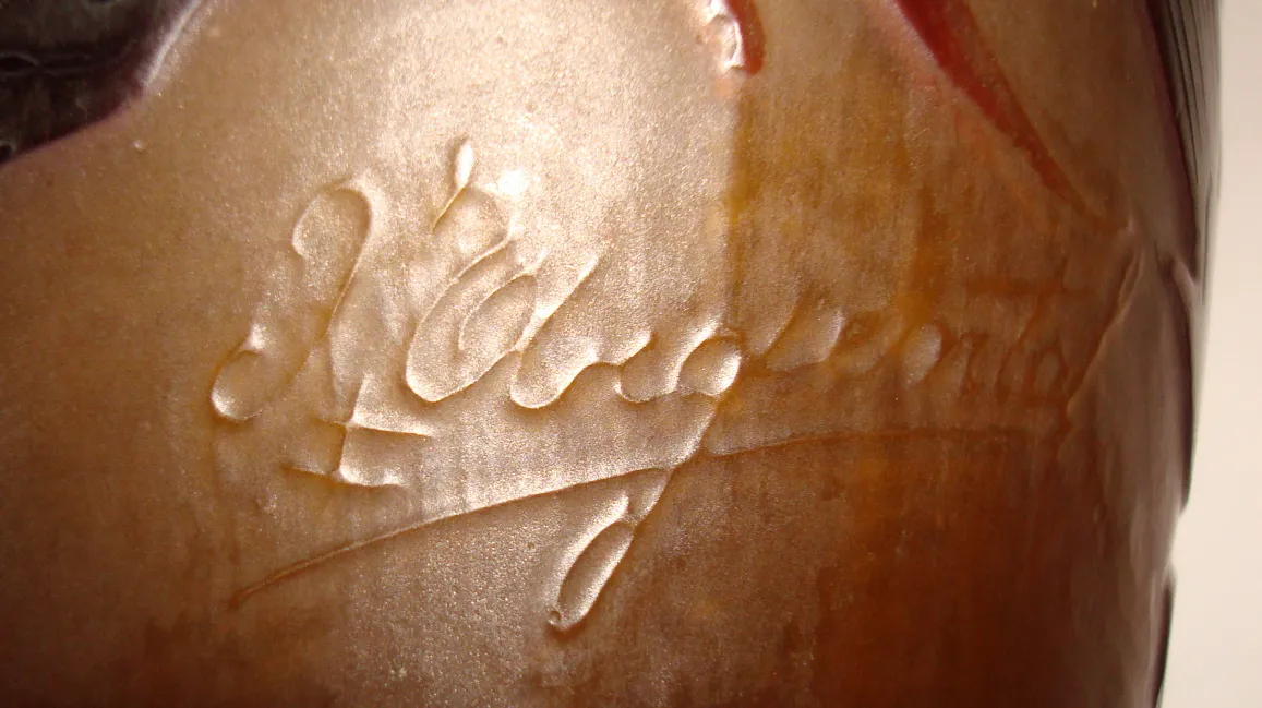 Antique glass signed D'Argental, displayed in an elegant setting.