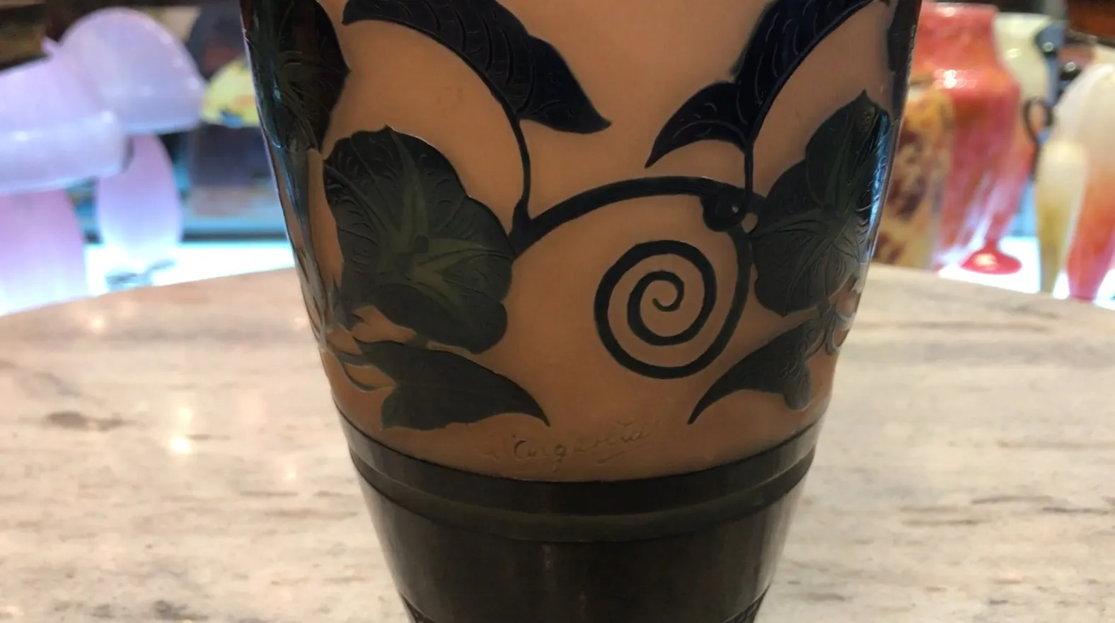 Signed D'Argental glass with leaf design on light background.