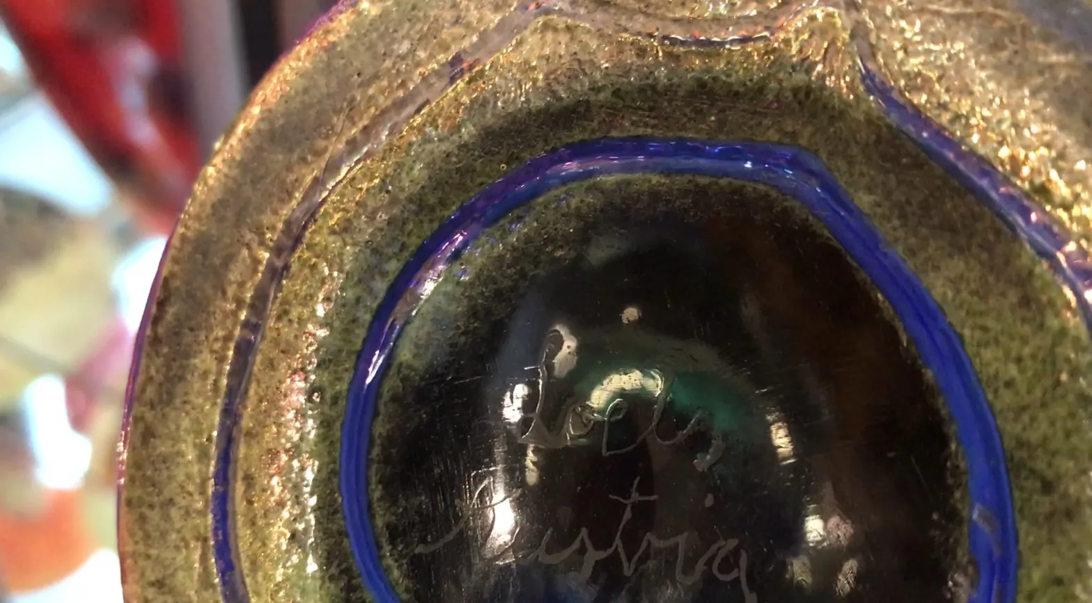 Signed Loetz glass with colorful details on the base.