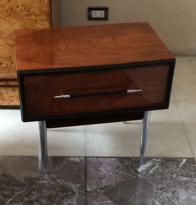 antique bedside table with drawer and elegant legs in a modern setting